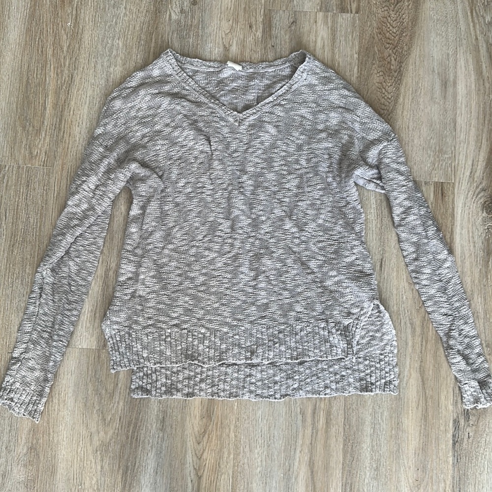 Light oatmeal colored sweater slightly longer in back than front